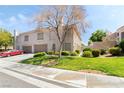 Charming two-story home with well-manicured lawn, tree, and mature landscaping at 502 Cosmic Star Pl, Henderson, NV 89052
