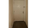 A clean white front door with secure hardware and neutral surroundings at 5220 Indian River Dr # 277, Las Vegas, NV 89103