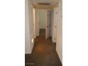 Hallway featuring neutral walls and flooring, with multiple doorways at 5220 Indian River Dr # 277, Las Vegas, NV 89103