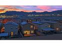 Stunning aerial view of the neighborhood with mountain views at sunset at 5252 Sunstone Mesa Dr, Las Vegas, NV 89166