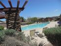 Community pool area with lounge chairs and mountain views at 5488 Apron Ct, Las Vegas, NV 89122