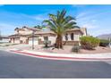 Charming single-story home with desert landscaping, a palm tree, and attached two-car garage at 5600 Blue Peak Ave, Las Vegas, NV 89131