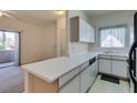 Efficient kitchen featuring white cabinets, laminate countertops, and modern appliances perfect for everyday meal prep at 5751 E Hacienda Ave # 105, Las Vegas, NV 89122