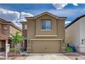 Two-story home with a two-car garage, desert landscaping, and a well-maintained lawn at 6231 Portland Treaty Ave, Las Vegas, NV 89122