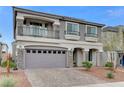 Inviting two-story home with stone accents, upper balcony, two-car garage, and desert-style landscaping at 6618 Tangled Vines Ave, Las Vegas, NV 89139