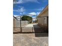 Sturdy metal gate securing access to the backyard or property, providing security and privacy at 6841 Longmeadow Dr, Pahrump, NV 89061
