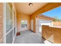 Covered patio with space for outdoor seating, a security gate, and front door access at 6916 Dorita Ave # 102, Las Vegas, NV 89108