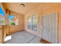 Covered porch showcasing a security gate, a decorative welcome mat, and neutral stucco at 6916 Dorita Ave # 102, Las Vegas, NV 89108