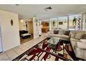 Open-concept living room with tile flooring, neutral paint, and lots of natural light at 6955 Grassy Knoll St, Las Vegas, NV 89147