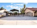 Gated property with a metal canopy structure provides ample parking and privacy at 711 Sari Dr, Las Vegas, NV 89110