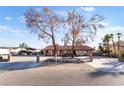 Single-story home with a red tile roof, long driveway, and desert landscaping offers curb appeal at 711 Sari Dr, Las Vegas, NV 89110