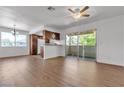Living room with wood-look flooring, a sliding door to a patio, and a breakfast bar to the kitchen at 7200 Pirates Cove Rd # 2025, Las Vegas, NV 89145