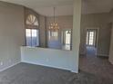 Open-concept living room offering plush carpeting and views to the kitchen and other living spaces at 734 Rusty Spur Dr, Henderson, NV 89014