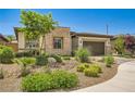 Attractive single-story house with stone facade, two-car garage, and desert landscaping at 7473 Deschutes Cir, Las Vegas, NV 89129