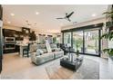 Open concept living area with a modern kitchen and a sliding glass door to the backyard at 7473 Deschutes Cir, Las Vegas, NV 89129