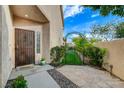 Inviting front entrance with a decorative security door, manicured garden, and stone pathway at 7709 Sierra Paseo Ln, Las Vegas, NV 89128