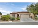 Charming single-story home featuring a well-maintained front yard, two car garage, and neutral stucco at 7908 House Sparrow St, North Las Vegas, NV 89084