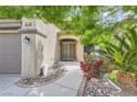 Inviting front entrance with a well-kept walkway, beautiful plants, and a charming front door at 8217 Fritzen Ave, Las Vegas, NV 89131