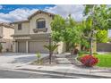 Charming home with a two-car garage, lush landscaping, and a welcoming walkway leading to the front door at 8217 Fritzen Ave, Las Vegas, NV 89131