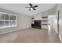 Bright living room featuring a brick fireplace and tile floors at 908 Coral Isle Way, Las Vegas, NV 89108