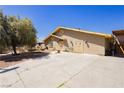 Side view of home with large driveway and double-door entrance at 997 N Christy Ln, Las Vegas, NV 89110