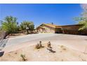 Spacious property featuring a long driveway, covered parking, and mature trees at 997 N Christy Ln, Las Vegas, NV 89110