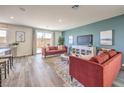 Cozy living room with a modern sofa, a large TV, and sliding doors to a patio at 1019 Gentle Swan St # 693, Henderson, NV 89011