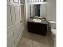 Bathroom with dark wood cabinets, granite countertop, and a shower with glass doors at 10245 S Maryland Pkwy # 2216, Las Vegas, NV 89183