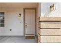 Welcoming front entrance with a stylish door and decorative sconce lighting at 10508 Waking Cloud Ave, Las Vegas, NV 89129