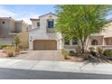 Charming stucco home with a two-car garage and beautifully designed desert landscaping at 1105 Strada Pecei, Henderson, NV 89011