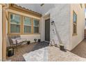 Inviting entrance with seating, potted plants, and a paved walkway leading to the front door at 1105 Strada Pecei, Henderson, NV 89011