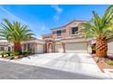 Stunning two-story stucco home featuring a three-car garage, beautiful stonework, and mature landscaping at 11275 Gammila Dr, Las Vegas, NV 89141