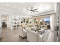 Inviting living room with stylish furnishings, open floor plan, and access to an outdoor patio with mountain views at 12217 Tempestad Ave, Las Vegas, NV 89138