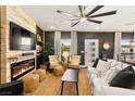 Inviting living room boasts a fireplace, large ceiling fan, neutral color scheme, and bright natural light at 12648 Heritage Bend Dr, Las Vegas, NV 89138