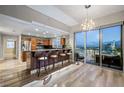 Open kitchen with stainless appliances, island seating, and city views through floor-to-ceiling windows at 150 Las Vegas Blvd # 1507, Las Vegas, NV 89101