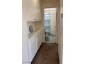 Hallway featuring built-in cabinets leading to bathroom with a shower at 1676 Divinity St, Las Vegas, NV 89142