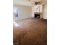 Spacious living room with a brick fireplace and ample natural light at 1676 Divinity St, Las Vegas, NV 89142