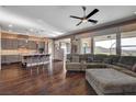 Open floor plan with hardwood floors seamlessly connects the living room to the kitchen at 19 Contrada Fiore Dr, Henderson, NV 89011