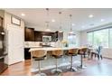 Modern kitchen with an island, white countertops, stainless steel appliances, and dark wood cabinets at 2090 Morro Vista Dr, Las Vegas, NV 89135