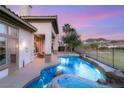 Sparkling pool with rock features, surrounded by lush landscaping and golf course views at 21 Avenida Sorrento, Henderson, NV 89011