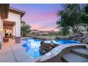 Resort style pool with rock waterfall and mountain views at sunset at 21 Avenida Sorrento, Henderson, NV 89011