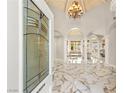 Grand foyer showcasing marble flooring, arched doorways, high ceilings, and an elegant chandelier at 2101 Diamond Bar Dr, Las Vegas, NV 89117