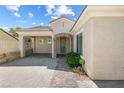 Charming single-story home featuring a covered entrance with stone accents and desert landscaping at 2164 Sawtooth Mountain Dr, Henderson, NV 89044