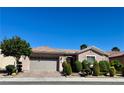 Inviting one-story home with well-maintained landscaping, a two-car garage, and a beautiful stone entryway at 2312 Indigo Island St, Henderson, NV 89044