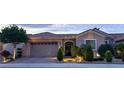 Charming single-story home with well-manicured landscaping, stone accents, and a two-car garage at 2312 Indigo Island St, Henderson, NV 89044