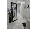 Hallway featuring a large decorative mirror and art leading to other rooms in the home at 2631 Bed Knoll Ct, North Las Vegas, NV 89031