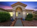 Inviting front entrance features an arched portico, decorative wreath, and desert landscaping at 2725 Byron Dr, Las Vegas, NV 89134