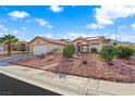 Charming one-story home with low-maintenance desert landscaping and a two-car garage on a sunny day at 2725 Byron Dr, Las Vegas, NV 89134