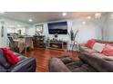 Cozy living room with a fireplace, a large TV, modern lighting and view to the kitchen and dining area at 2851 S Valley View Blvd # 1132A, Las Vegas, NV 89102