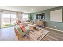 Open-concept living room featuring modern furniture and sliding glass doors to the backyard at 3402 La Cura Ave # Lot 69, Las Vegas, NV 89141